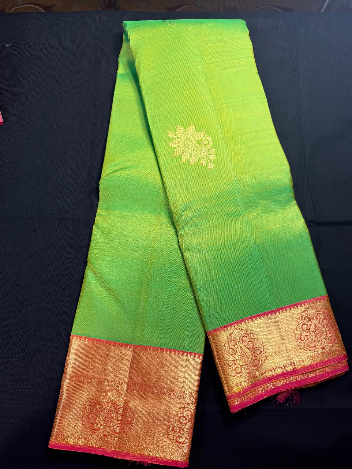 Green Pure Kanjivaram Pattu with peacock butas all over, pink border with rudraksha and leaf design