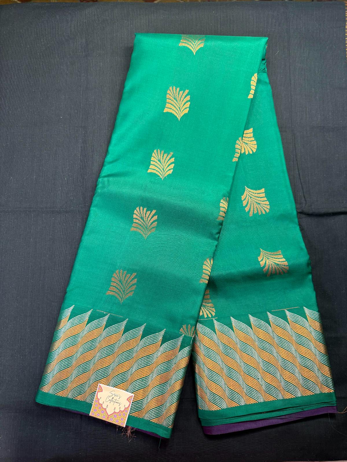 Green Pure Kanjivaram Pattu with copper jari leaf butas and silver and copper wavy border