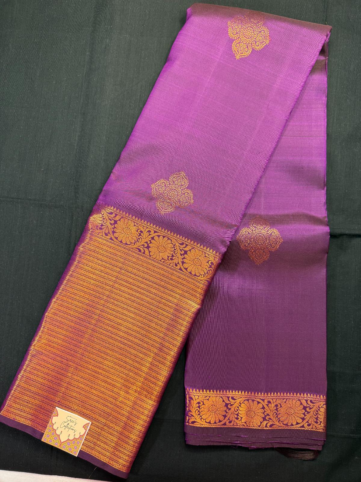 Purple pure kanjivaram pattu with copper jari butas all over, big heavy copper border