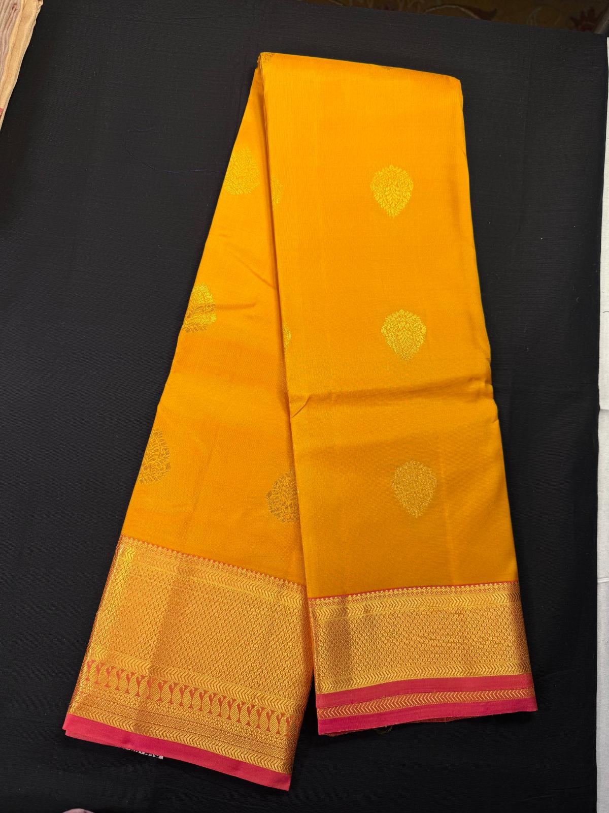 Yellow Pure Kanjivaram Pattu, With Pink Double Border, All Over Medium Size Gold Butas