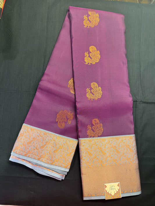 Purple pure kanjivaram pattu with copper peacock butas all over and gray border and kadi border, with copper jari