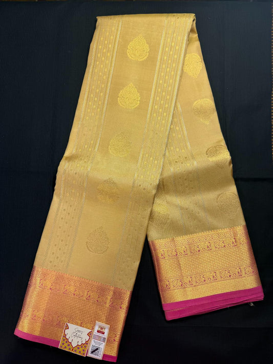 Beige Pure Kanjivaram Pattu with all over lines and goldand silver butas, with elephant and peacock in pink border