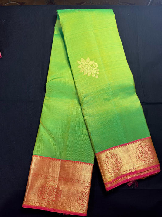 Green Pure Kanjivaram Pattu with peacock butas all over, pink border with rudraksha and leaf design