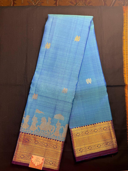 Sky blue, with peacock butas all over, pallaki design with purple border including rudrakshas