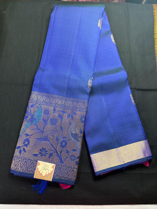 Royal blue Pure Kanjivaram Pattu, with all over rudraksha design jari butas, meenakari border, blue, silver and gold peacocks