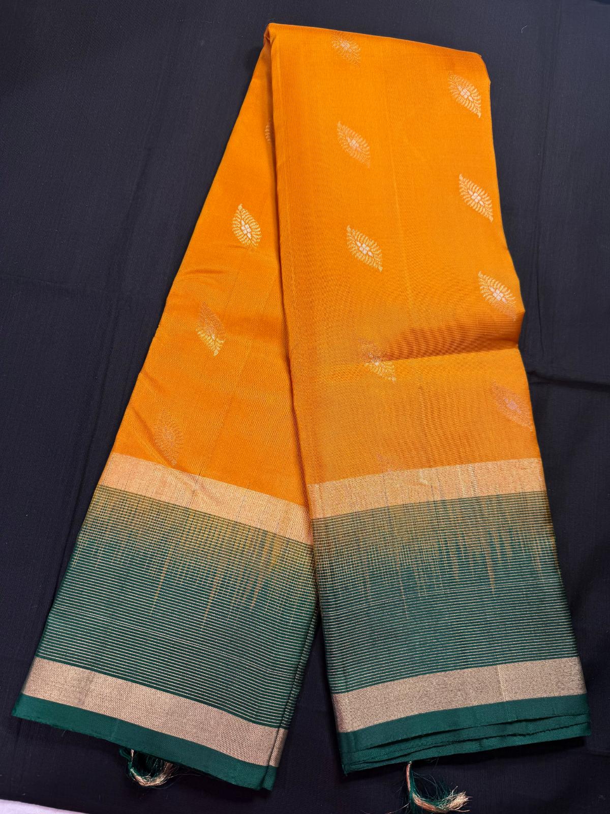 Mustard yellow pure kanjivaram pattu with silver, and jari leaf butas all over, gap border and horizontal lines