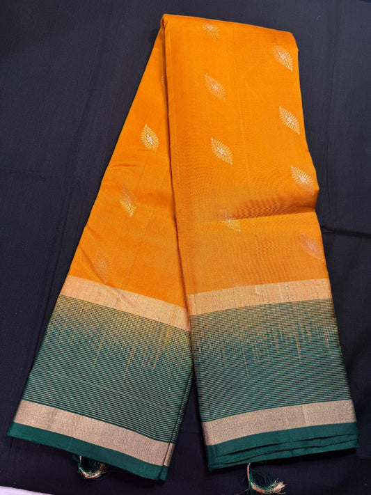 Mustard yellow pure kanjivaram pattu with silver, and jari leaf butas all over, gap border and horizontal lines
