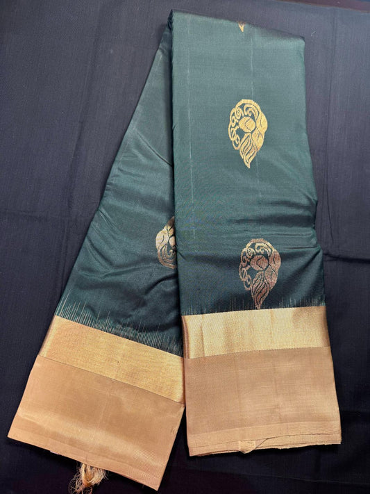 Bottle green pure kanjivaram Pattu with big gold butas all over and kadi border and plain beige border