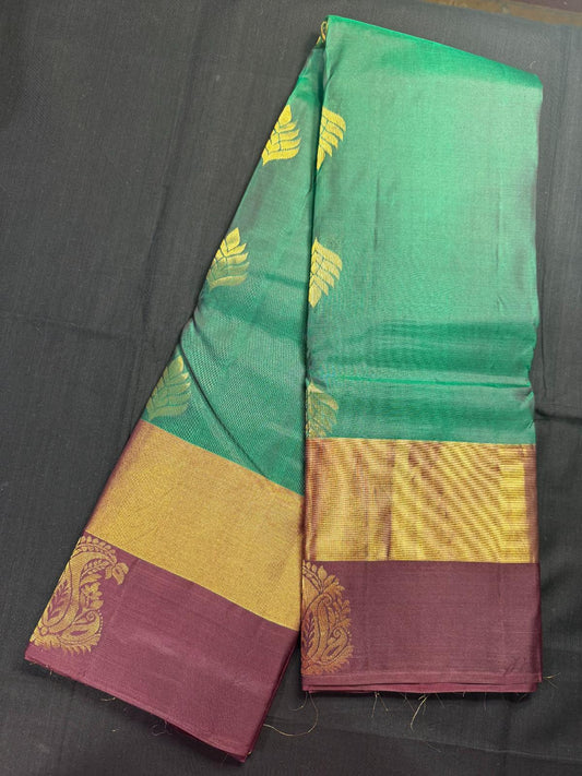 Green pure kanjivaram Pattu with big gold leaf butas all over and double border, kadi and marron with mango butas