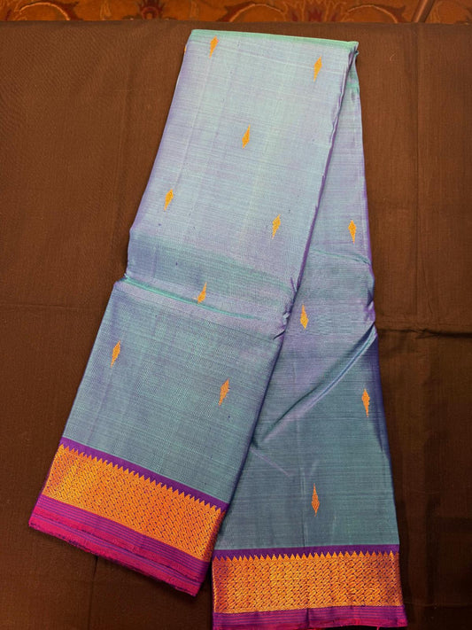 Skyblue and purple mixed pure Kanjivaram Pattu with all over butas, and purple kadi border
