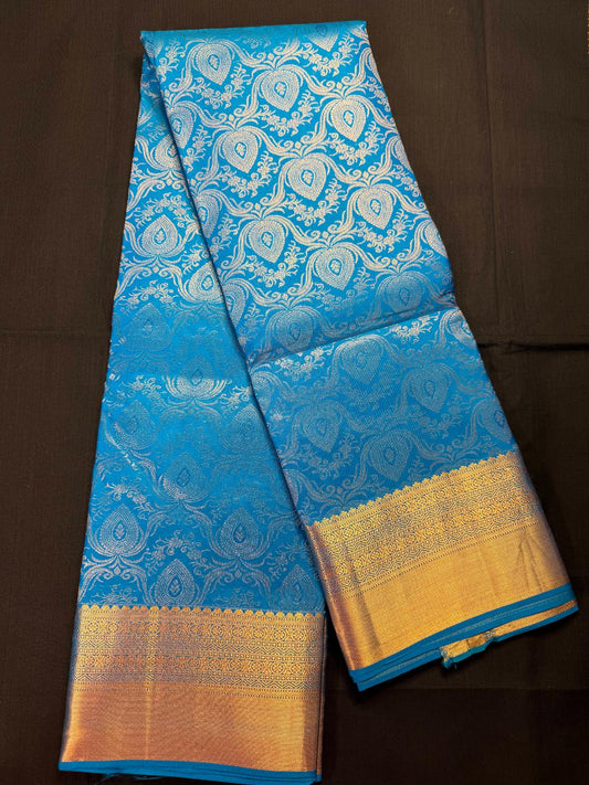 Teal blue pure Kanjivaram pattu withall over silver jacquard butas with blue thread, small border and kadi border