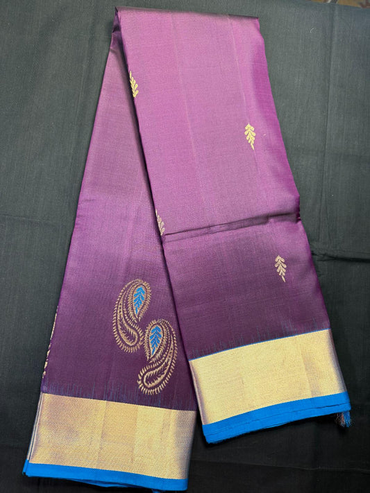 Purple pure kanjivaram pattu with jari butas all over, big mango butas with blue thread, and kadi border