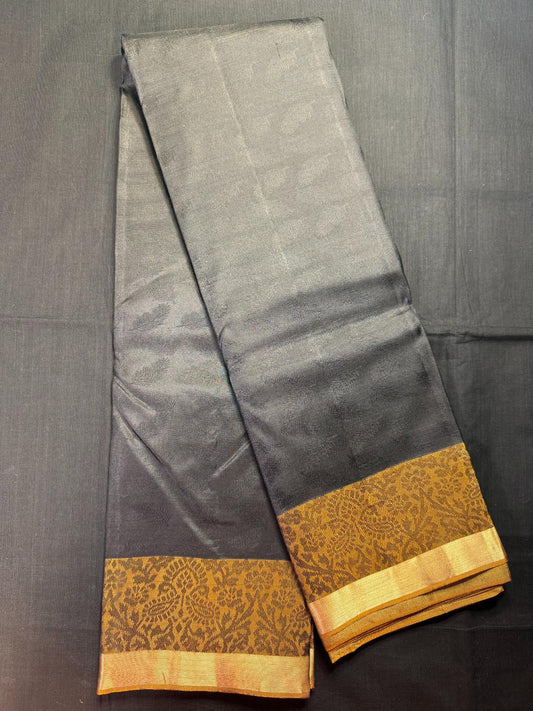Black Pure Kanjivaram Pattu with all over leaf and self butas with brown thread work border and jari kadi border