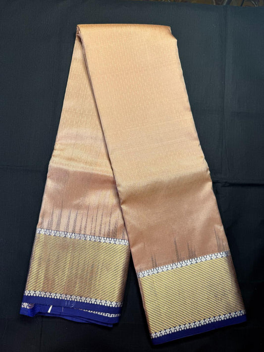 Beige Pure Kanjivaram Pattu with all over jari lines and royal blue border with Silver and gold Jari border