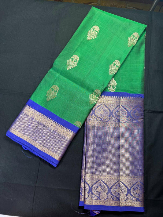 Green Pure Kanjivaram Pattu with gold butas all over and big royal blue border with peacocks, rudraksha