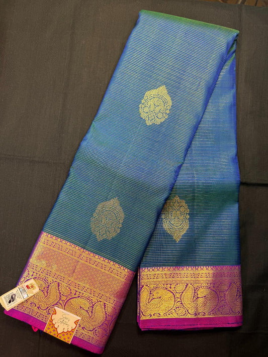 Blue vaira oosi pure kanjivaram pattu with big mango butas, with peacock design double border, magenta border