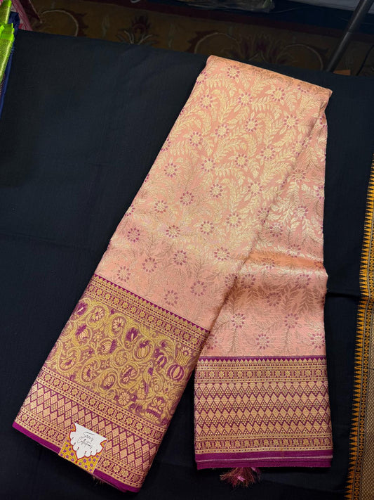 Peach pure kanjivaram pattu, with jacquard design with silver jari, magenta design, meenakari work, with lotus flowers and peacocks in magenta border