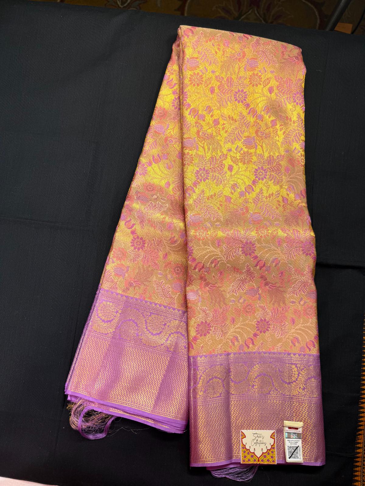 Gold pure kanjivaram pattu with meenakari design, jacquard, peacok and flowers, purple border with rangoli design