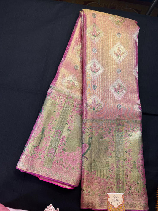 Pink pure kanjivaram pattu with gold tissue, all over jacquard butas, silver lines, meenakari border with peacocks, and garden