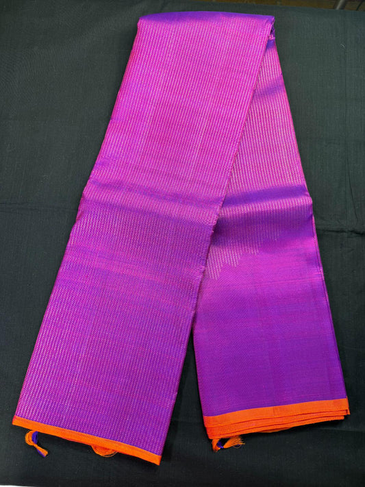 Magenta pure kanjivaram pattu with all over jari lines, increasing steps design, small orange border