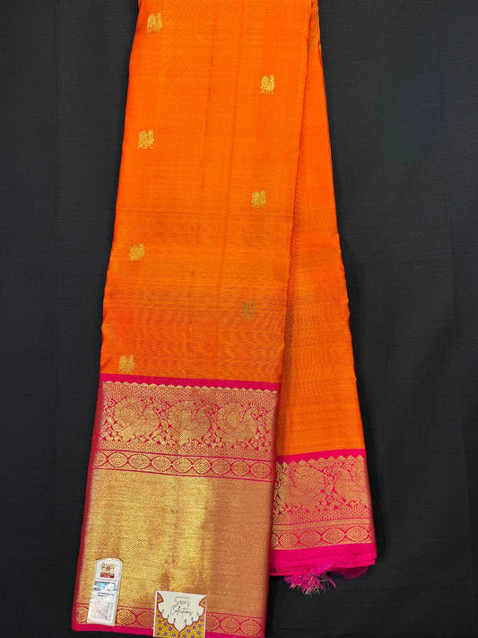 Orange pure kanjivaram pattu with all gold peacock butas, big pink border with rudraksha and peacocks design