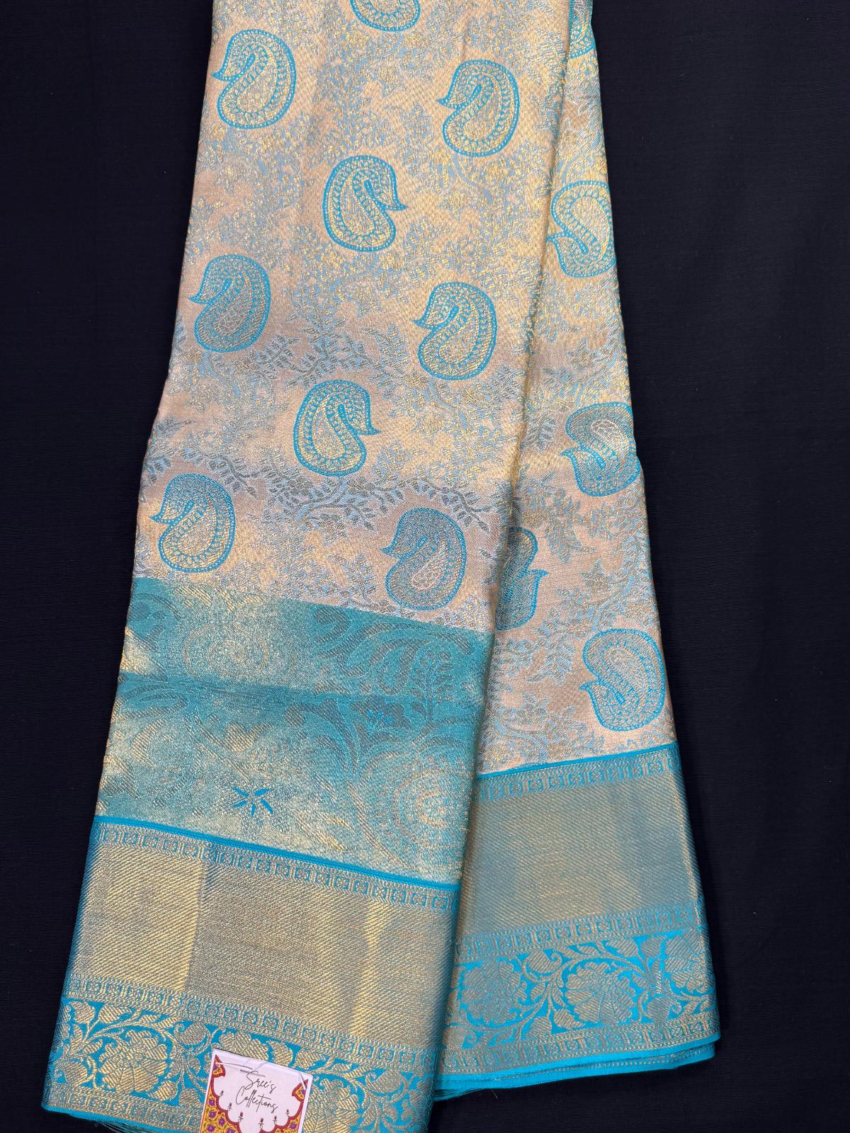 Teal green pure kanjivaram pattu with gold, silver mangos, all over jacquard, triple border including kadi and heavy designs