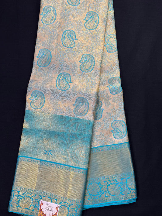 Teal green pure kanjivaram pattu with gold, silver mangos, all over jacquard, triple border including kadi and heavy designs