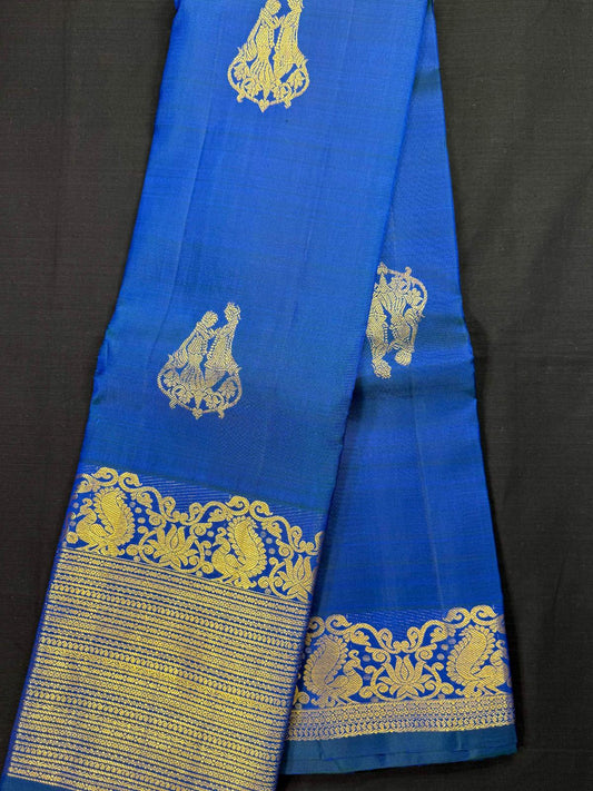 Royal blue Pure Kanjivaram Pattu, with all over wedding couple design, self big double border, peacocks and horizontal design